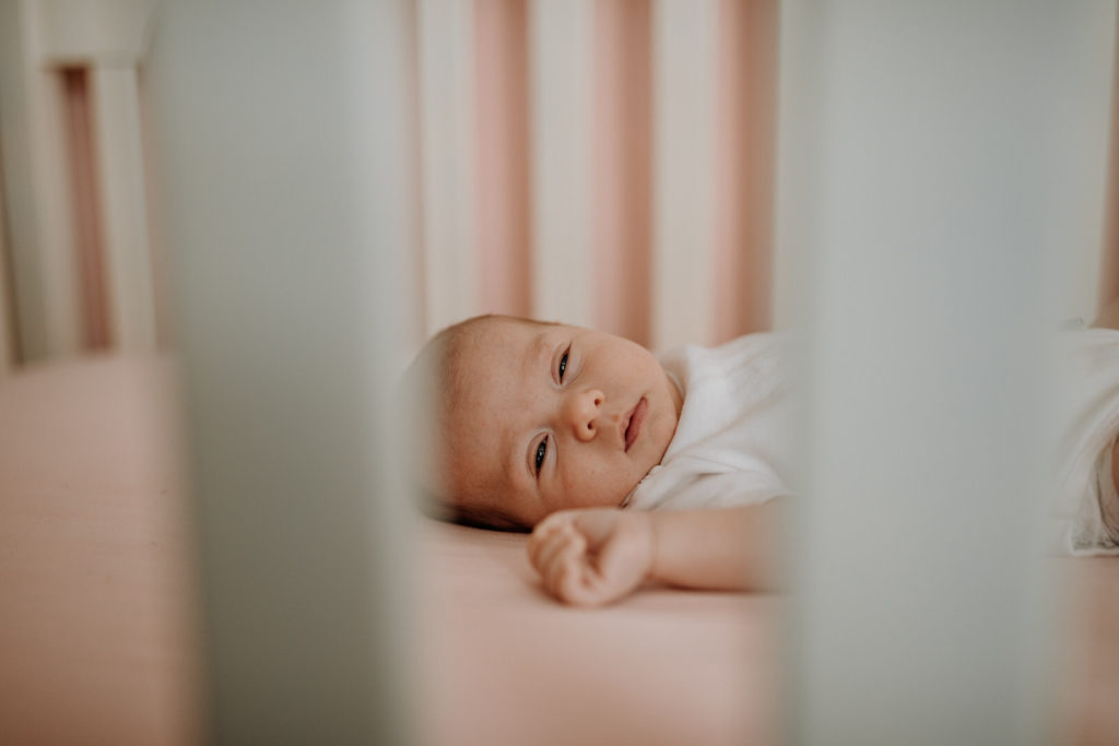 Young baby lying in crib