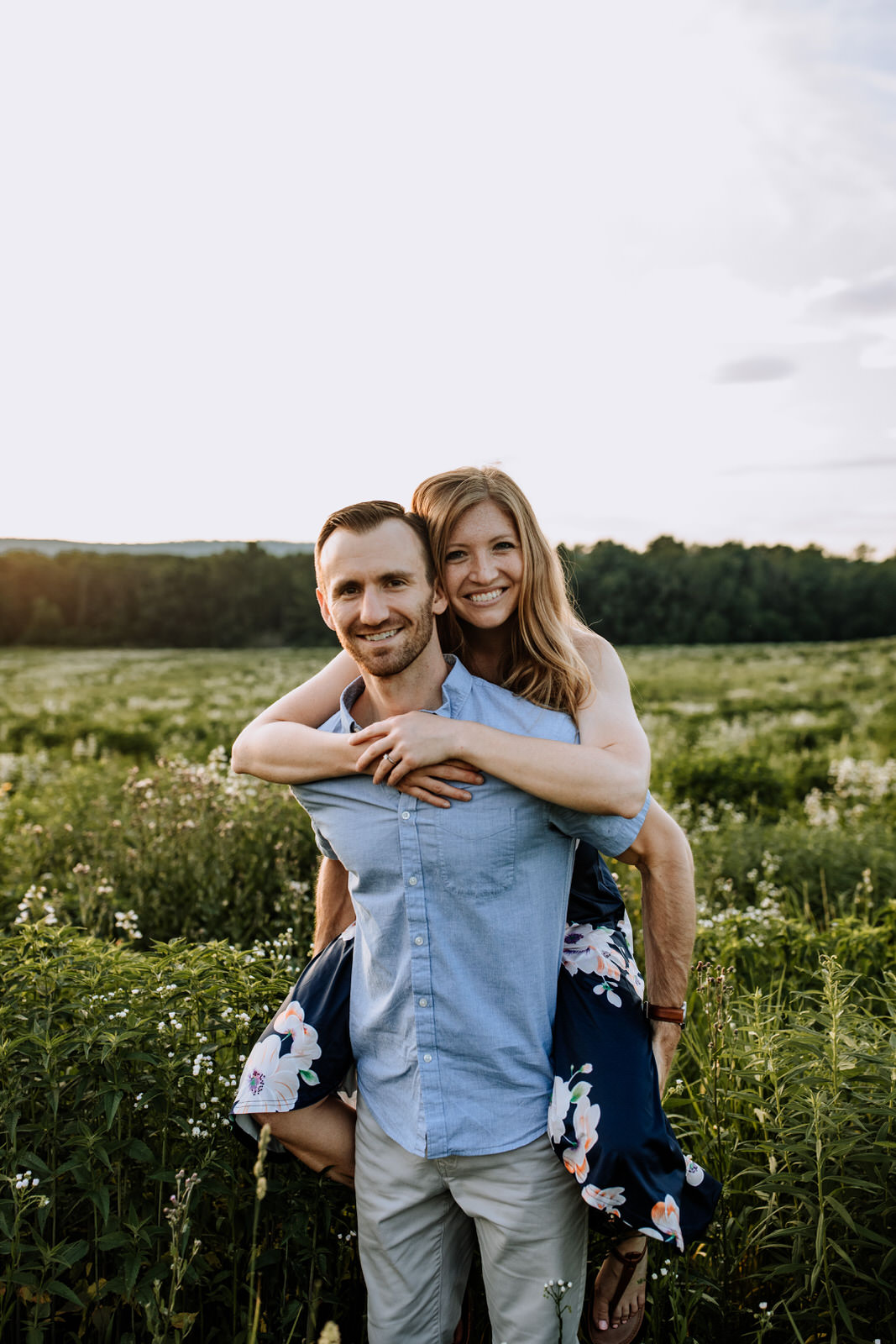 Man and woman looking at the camera for a portrait in wildflower field