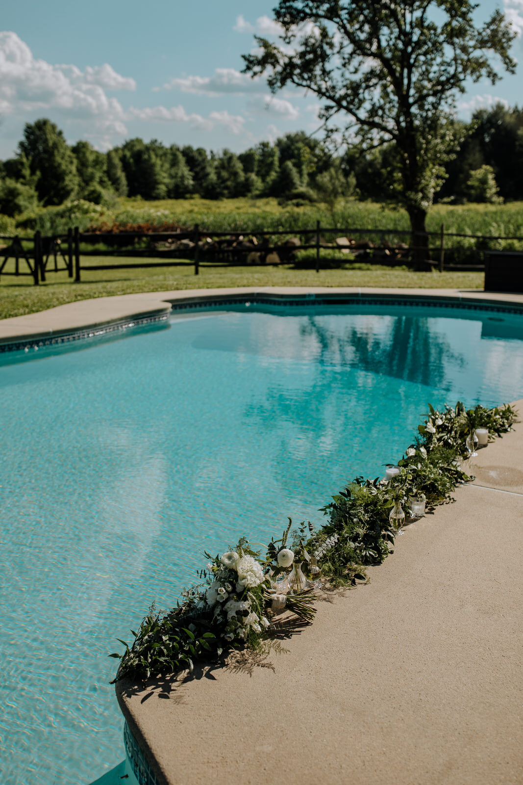 Swimming pool with wedding flower arrangements at Galvanized America Inn