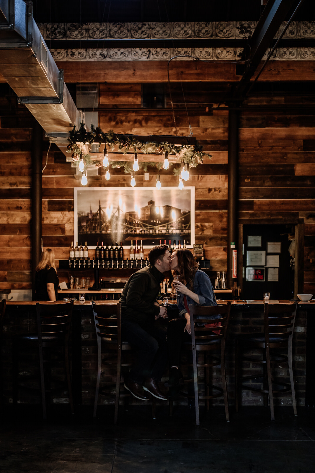 Couple kissing at bar at Easton Wine Project