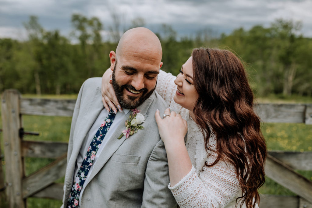 Candid bride and groom portrait featuring laughing and smiling couple