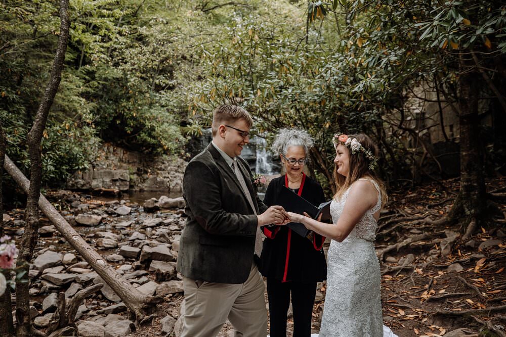 bride and groom get married in front of waterfall