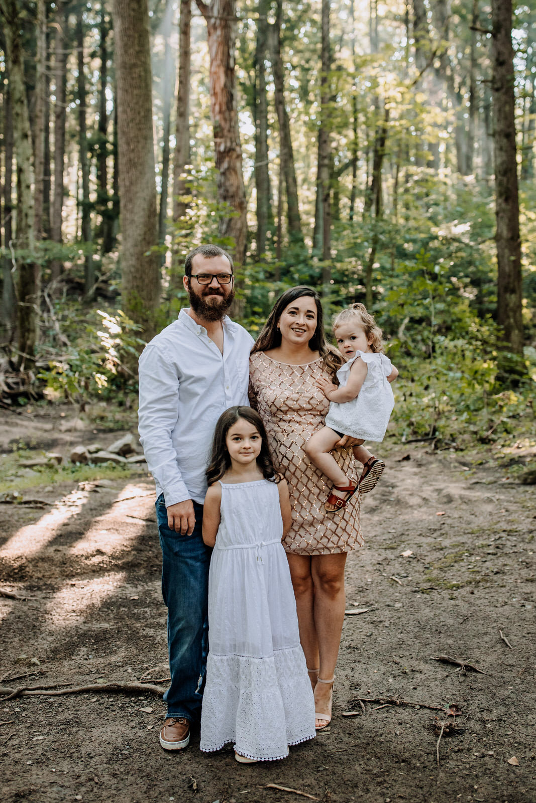 Family of 4 portrait in the woods