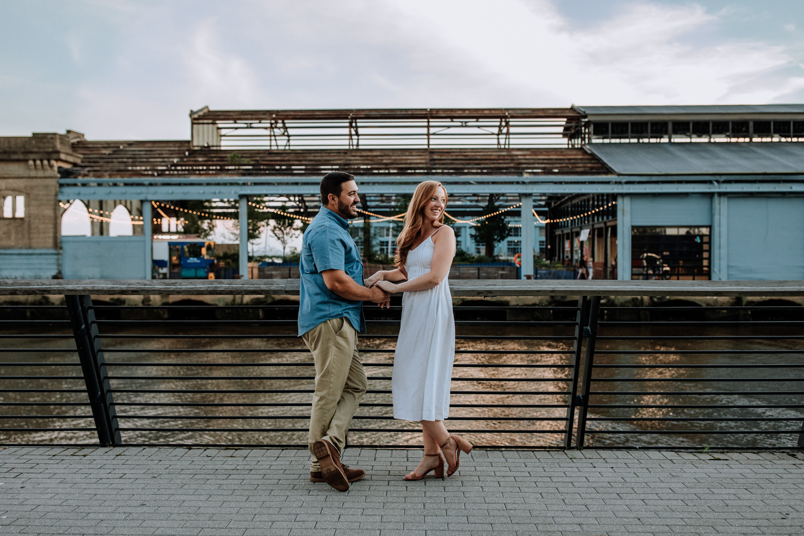 Couple standing in front of Cherry Street Pier in Philadelphia, PA