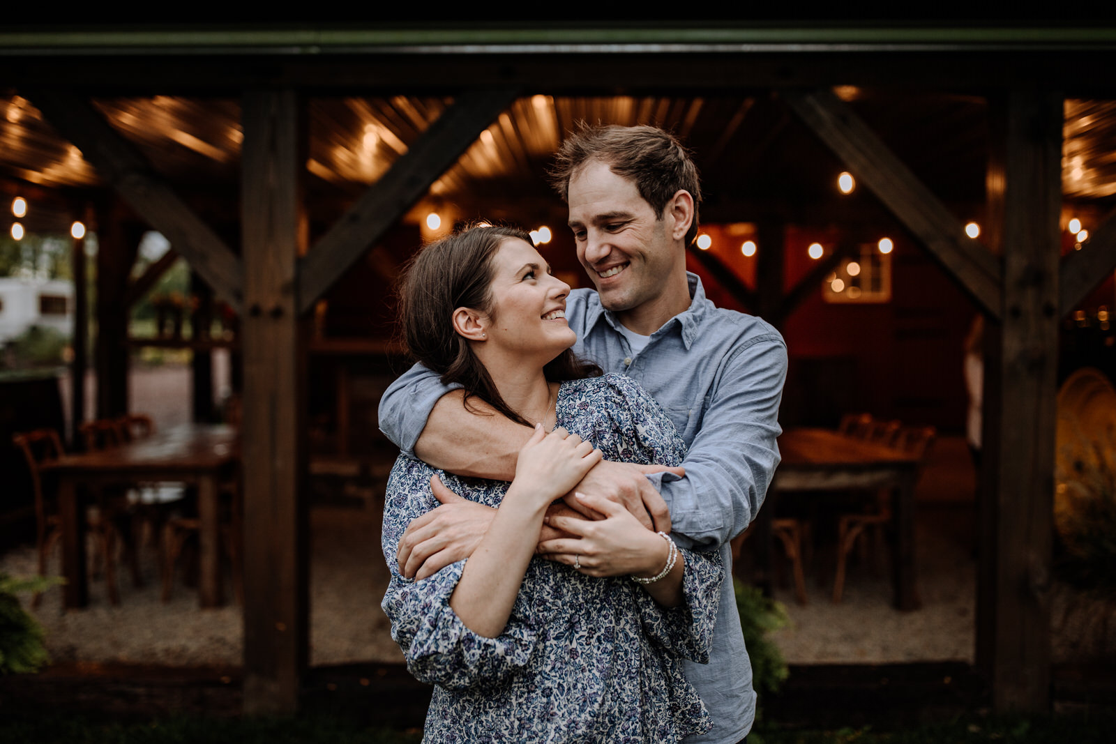 Picture of a couple in front of The Farm Bakery and Events string lights