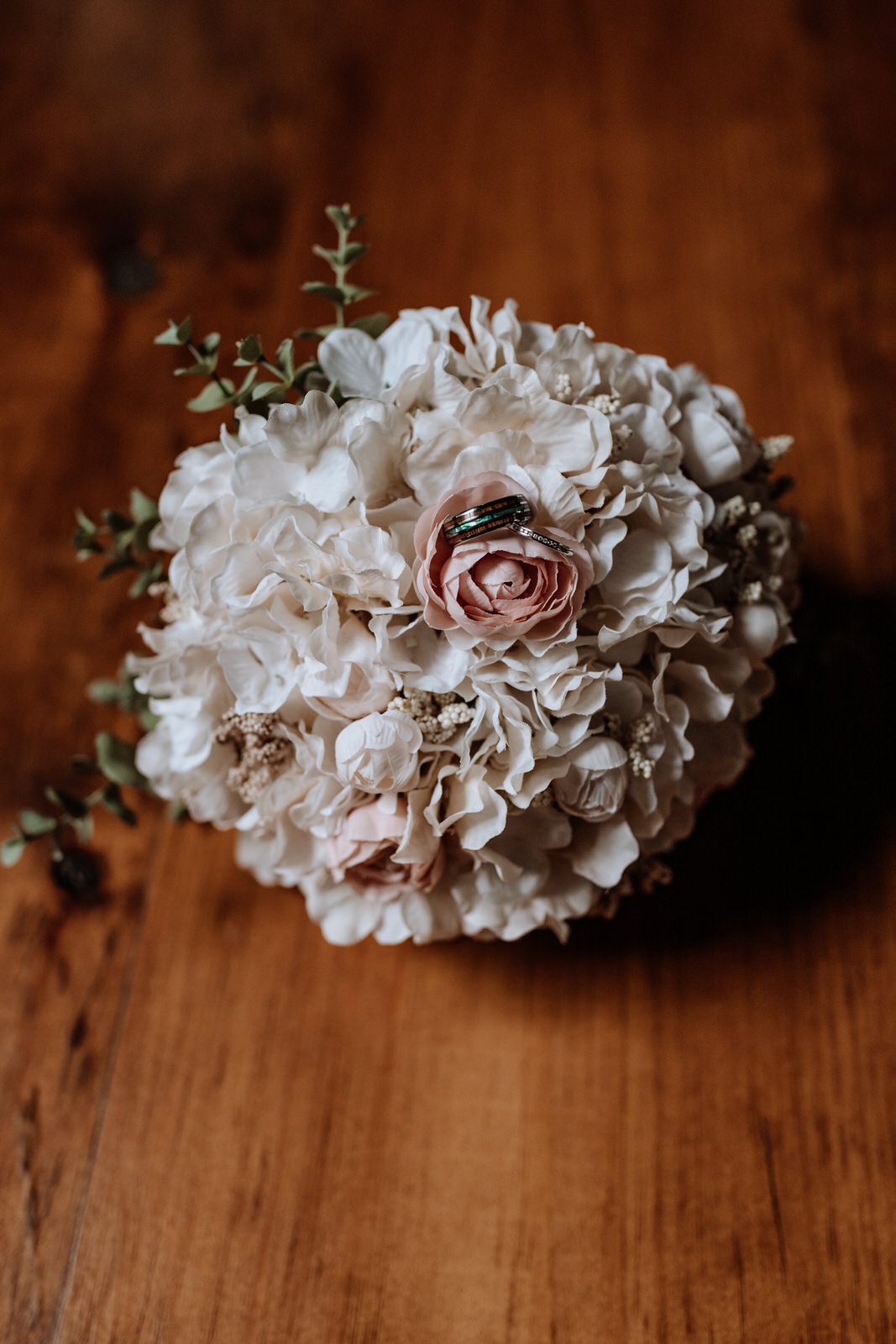 Wedding bouquet of flowers with rings on top