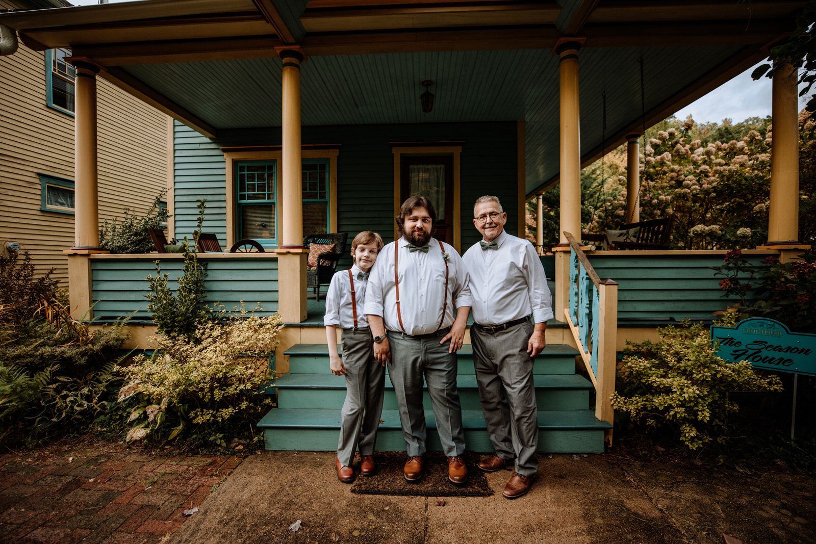 3 men standing outside of a house at The Pump House B&B