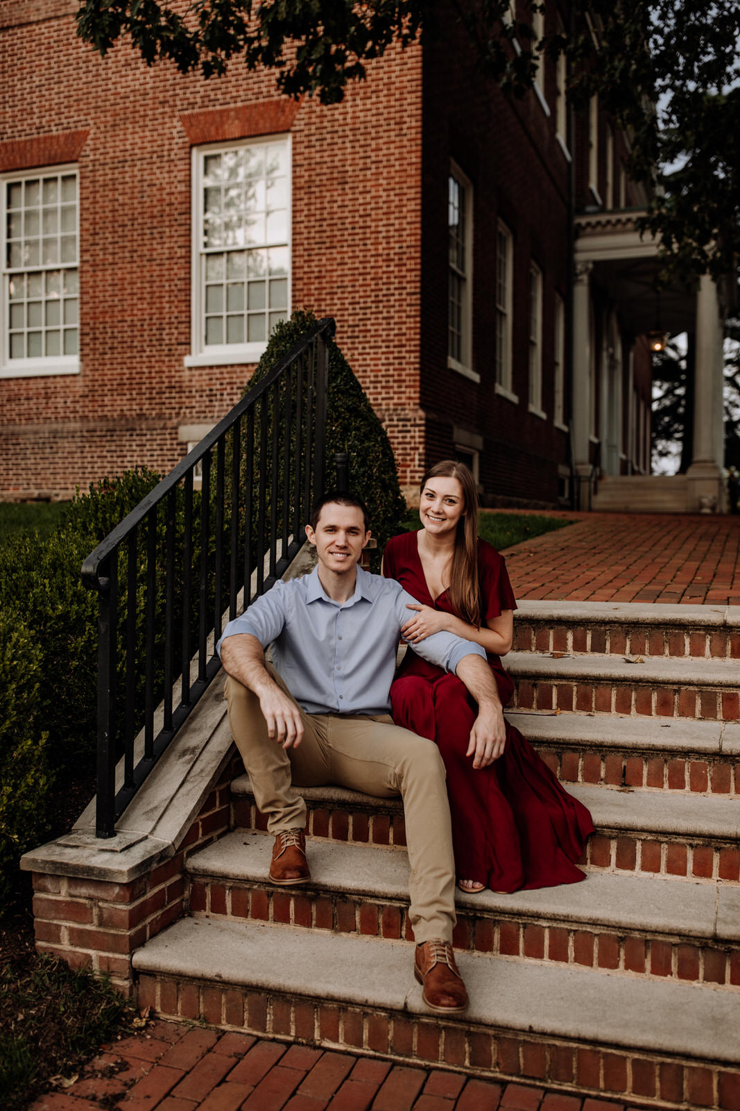 Man and woman looking at camera portrait - sitting on brick stairs in Annapolis, Maryland